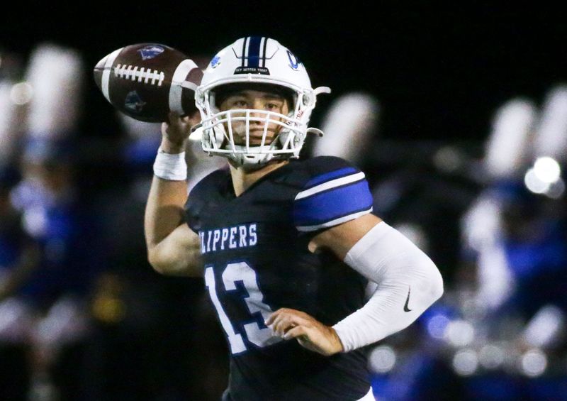 Clear Creek Amana’s Conlan Poynton (13) throws a pass against Burlington Friday, Oct. 4, 2024 in Tiffin, Iowa.
