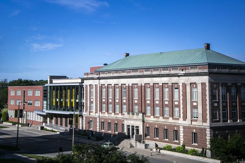 People walk past the Iowa Memorial Union on Madison Street, Wednesday, June 22, 2022, on the University of Iowa campus in Iowa City, Iowa.