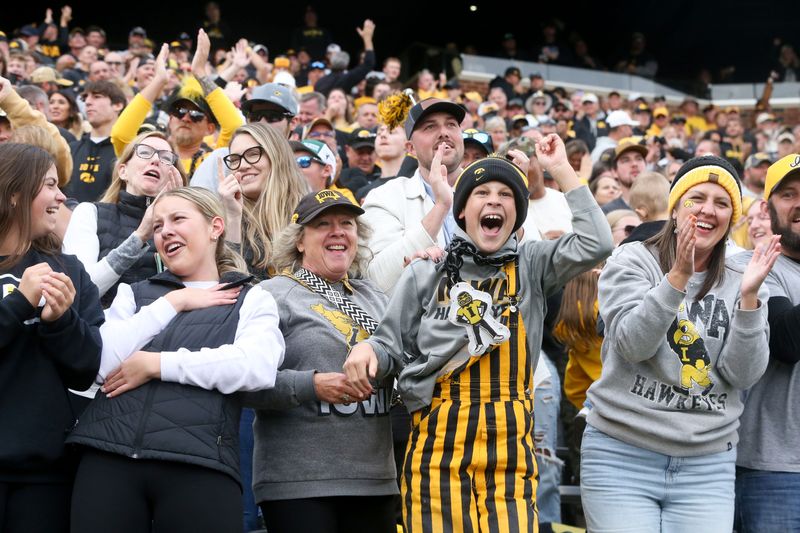 Iowa fans react after Iowa’s Kaden Wetjen (21) returns a Northwestern punt to the endzone Saturday, Oct. 26, 2024 at Kinnick Stadium in Iowa City, Iowa.