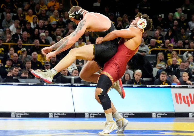 Iowa State’s Yonger Bastida attempts to take down Iowa’s Ben Kueter in a 285-pound match during the Cy-Hawk wrestling dual Saturday, Nov. 23, 2024 at Carver-Hawkeye Arena in Iowa City, Iowa.