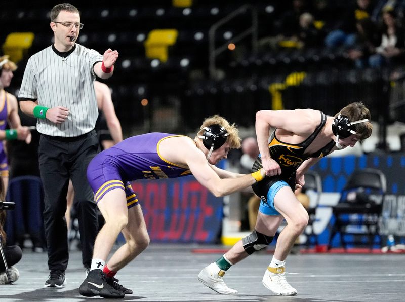 Iowa’s Dru Ayala escapes Northern Iowa’s Bowen Downey in a 125-pound match during the Soldier Salute wrestling tournament Sunday, Dec. 29, 2024 at Xtream Arena in Coralville, Iowa.