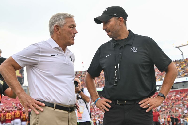 Sep 9, 2023; Ames, Iowa, USA; Iowa Hawkeyes head coach Kirk Ferentz (left) and Iowa State Cyclones head coach Matt Campbell (right) talk before the game at Jack Trice Stadium. Mandatory Credit: Jeffrey Becker-USA TODAY Sports