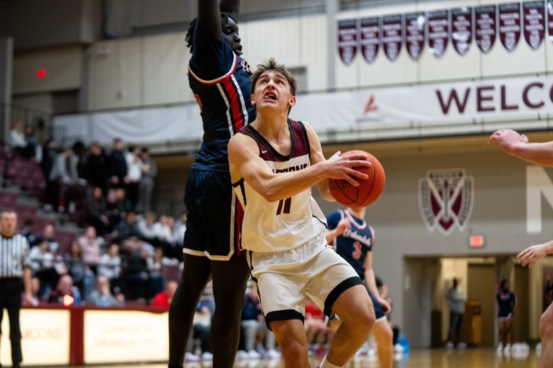 Dowling Catholic's Noah Martens (11) drives past his defender, Urbandale's Ter Kuel (11), on Friday, Jan. 10, 2025, at Dowling Catholic High School.