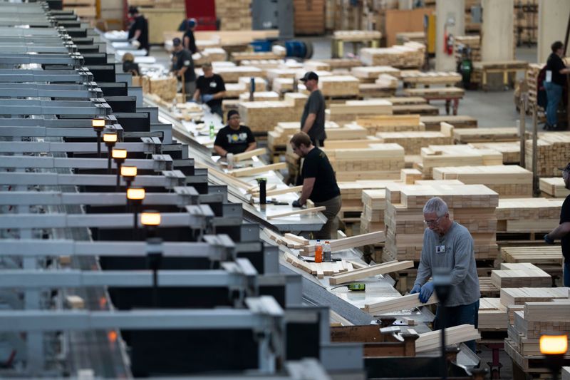 Workers construct materials for windows and doors at Pella Corporation's manufacturing facility on Tuesday, Feb. 4, 2025, in Pella.