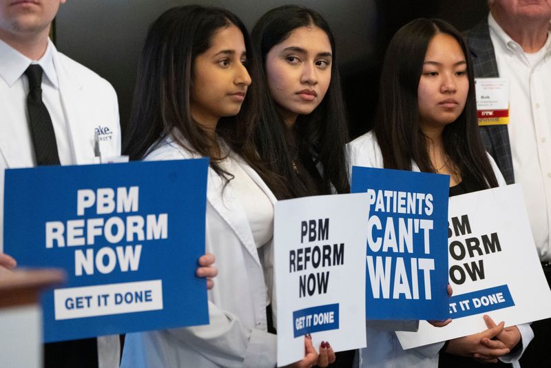 Pharmacy students stand during an Iowa Pharmacy Association press conference at the Iowa State Capitol on Wednesday, Feb. 5, 2025, in Des Moines.