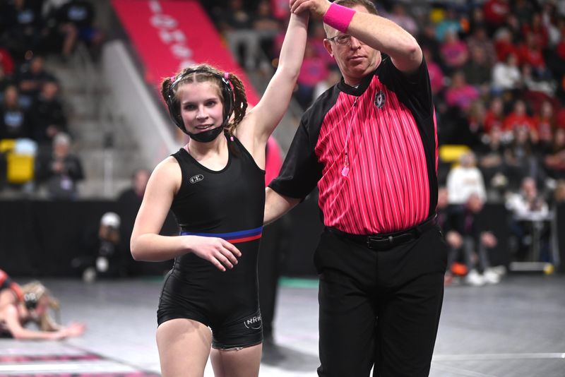 Raccoon River-Northwest's Cassidy McCallister has her hand raised after defeating Ankeny's Zoe Sullivan at 100 pounds during the IGHSAU state girls wrestling tournament on Thursday, Feb. 6, 2025, at the Xtream Arena in Coralville, Iowa.