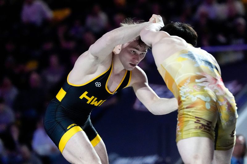 Spencer Lee wresltes Masanosuke Ono during an exhibition match at the “FloWrestling Night in America” event Wednesday, Feb. 26, 2025 at Xtream Arena in Coralville, Iowa.