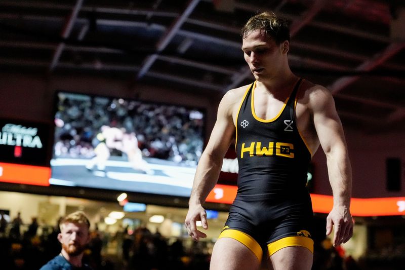 Spencer Lee walks off the mat after an exhibition match against Masanosuke Ono at the “FloWrestling Night in America” event Wednesday, Feb. 26, 2025 at Xtream Arena in Coralville, Iowa.
