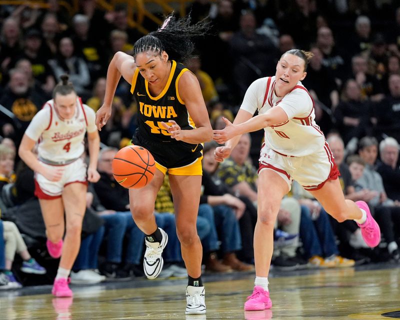 Iowa forward Hannah Stuelke (45) steals the ball from Wisconsin guard Halle Douglass (10) during a Big Ten conference game Sunday, March 2, 2025 at Carver-Hawkeye Arena in Iowa City, Iowa.