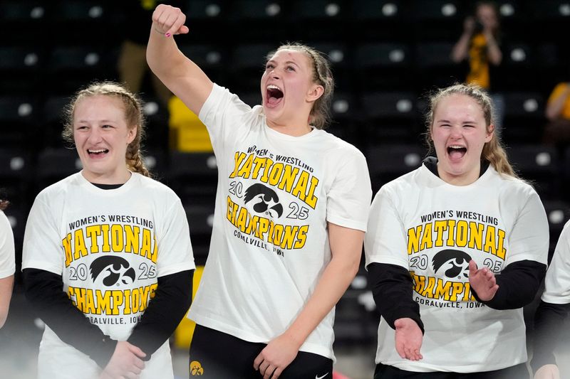 Iowa’s Macey Kilty, Kylie Welker and Jaycee Foeller celebrate after the team’s first-place finish at NCWWC’s Saturday, March 8, 2025 at Xtream Arena in Coralville, Iowa.