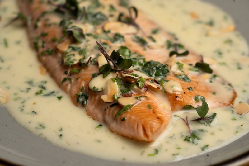 Pan-roasted steelhead trout comes with an almond-lemon butter sauce is on the menu at Guesthouse Tavern + Oyster.
