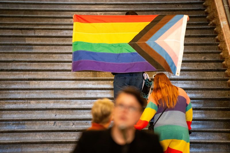 A pride flag is walked up the stairs of the Stae Capitol during LGBTQ+ Day on the Hill on Tuesday, March 11, 2025.