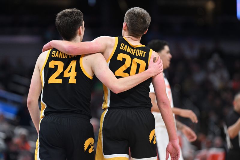 Pryce and Payton Sandfort share a hug while playing their last game together for Iowa on March 13, 2025, in the Big Ten Tournament in Indianapolis.