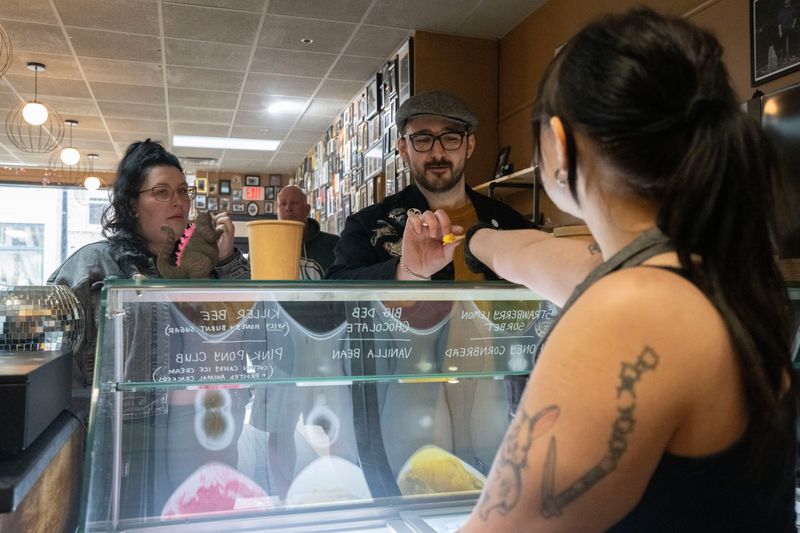 Customers taste test ice cream flavors at Black Cat Ice Cream in Valley Junction on Tuesday, April 1, 2025, in West Des Moines.