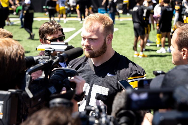 Apr 26, 2025; Iowa City, IA, USA; Iowa offensive lineman Logan Jones (65) speaks with journalists after a spring NCAA football open practice at Kinnick Stadium. Mandatory Credit: Joseph Cress/For the Register