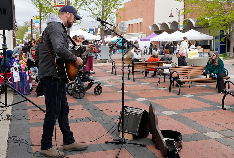 Singer Jake Doty performs at the season opening of the Ames Downtown Farmers’ Market on Main Street, May 3, 2025, in Ames, Iowa.