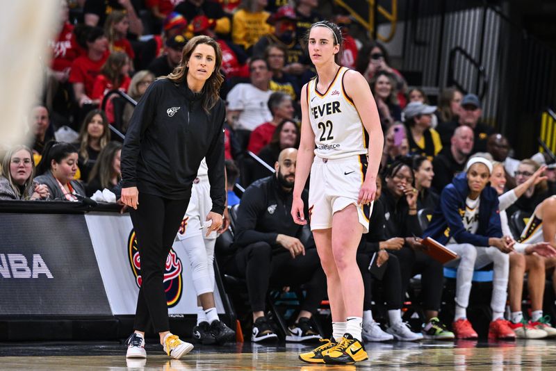 May 4, 2025; Iowa City, IA, USA; Indiana Fever guard Caitlin Clark (22) looks on with head coach Stephanie White during the third quarter against the Brazil National Team at Carver-Haweye Arena. Mandatory Credit: Jeffrey Becker-Imagn Images