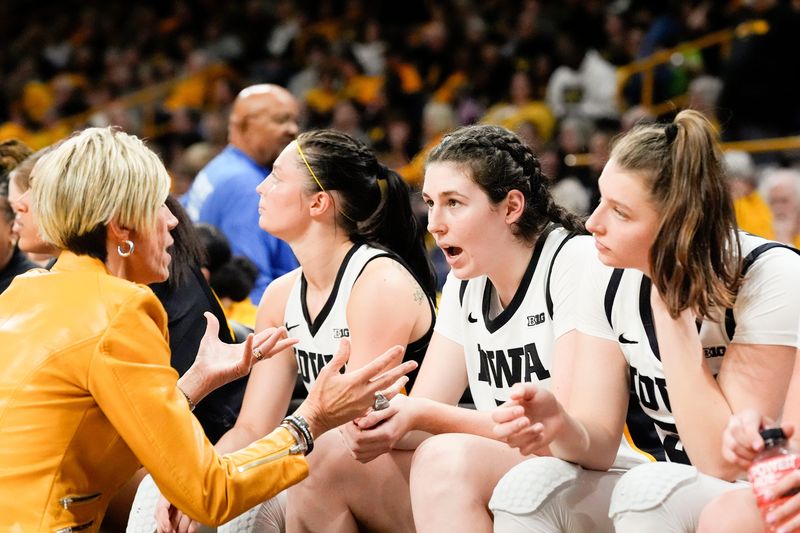 Iowa Hawkeyes head coach Jan Jensen talks to Iowa Hawkeyes center Ava Heiden (5) at the start of the second half against the Washington State Cougars Sunday, Nov. 24, 2024 at Carver-Hawkeye Arena in Iowa City, Iowa.