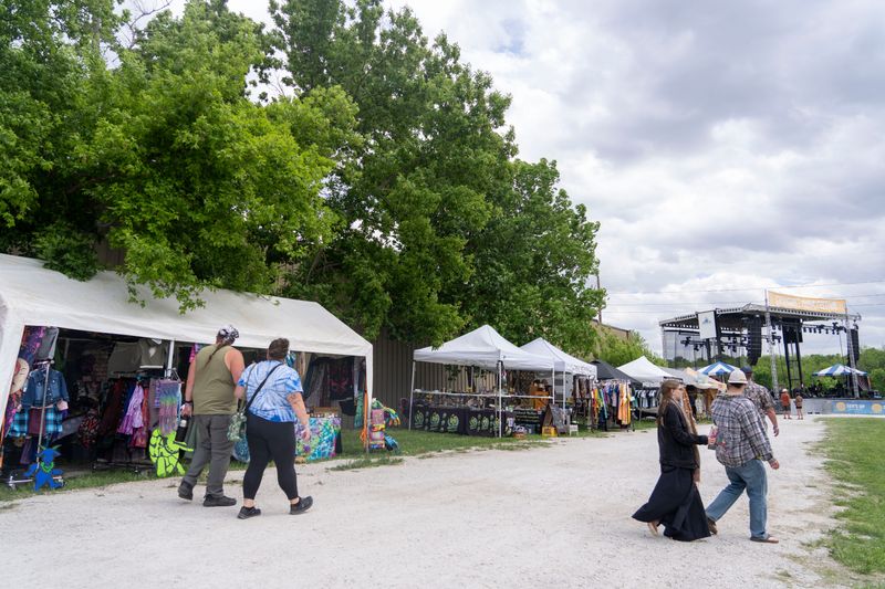 People walk by vendors at Greenbelt Music Festival at Horizon Events Center on May 16, 2025, in Clive.