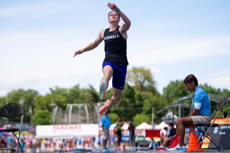 Norwalk's Kaiden Kunze takes to the air during the 4A boys long jump on May 23, 2025, at Drake Stadium.