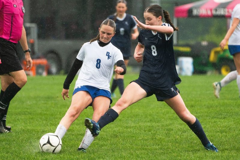 Bondurant-Farrar's Abby Chambers kicks the ball against Cedar Rapids Xavier's Deirdre Green during the 2025 IGHSAU state soccer tournament at Lied Recreational Fields on June 3, 2025, in Ames.