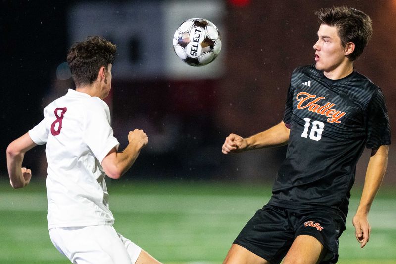 Valley's Leighton Hukee (18) and Ankeny's Jack Croskey (8) look to the ball during the 4A state semifinal on June 5, 2025, at Mediacom Stadium in Des Moines.