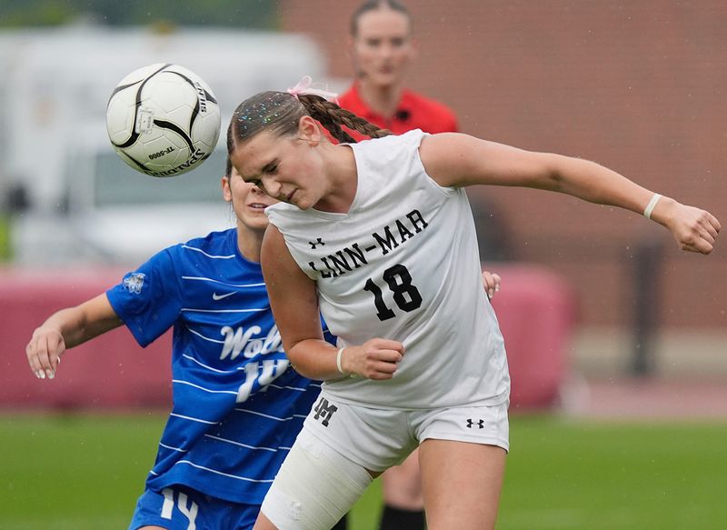Linn-Mar midfielder/forward Dreya Kern (18) heads the ball around Waukee Northwest's midfielder Josie Jones (14) during the second half at the Cyclone Sports Complex on Saturday, June 7, 2025, in Ames, Iowa.