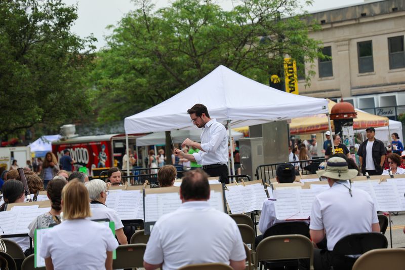 Rob Medd conducts the Iowa City Community Band at the Iowa Heathcare Main Stage during the Iowa Arts Festival Saturday, June 7, 2025, in downtown Iowa City, Iowa