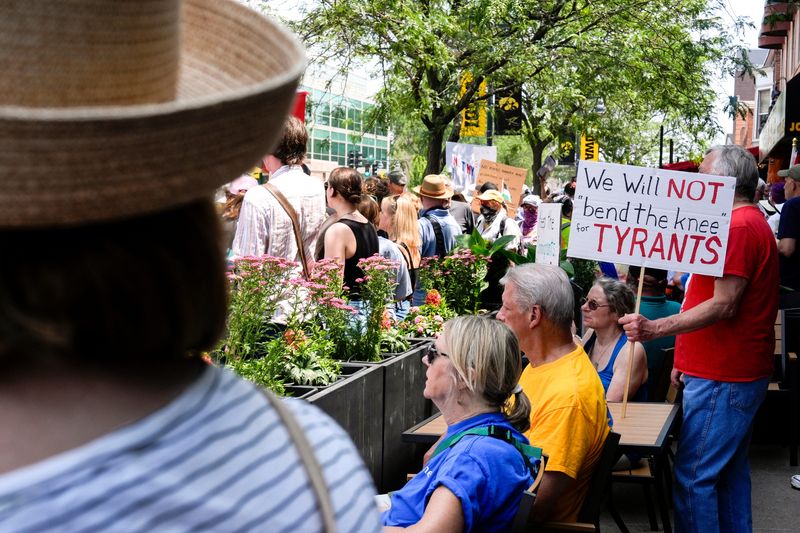 People gather for the “No Kings” protest June 14, 2025 in downtown Iowa City, Iowa.