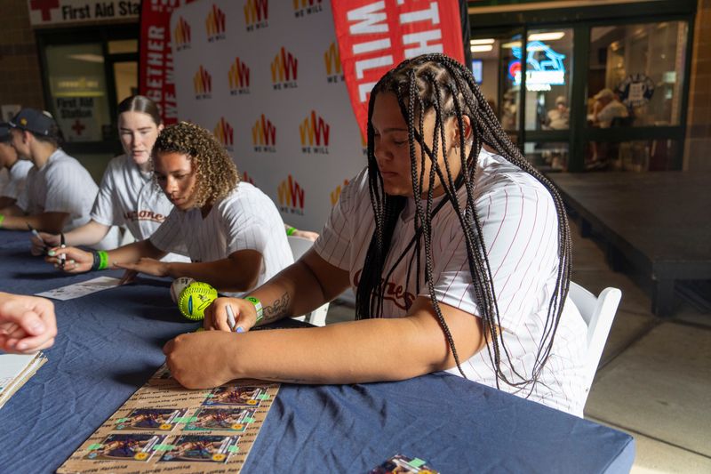 Iowa State basketball player Audi Crooks signs an autograph for a fan during an Iowa Cubs game at Principal Park on June 14, 2025, in Des Moines.
