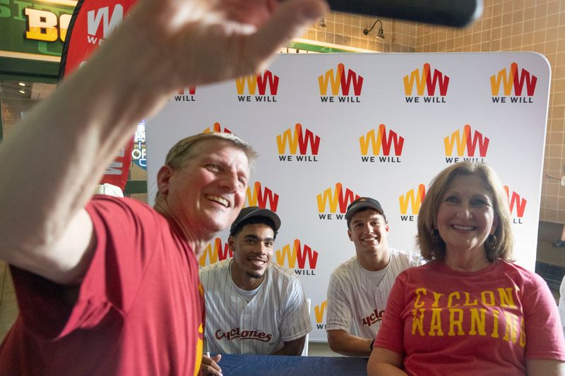 Iowa State basketball players Tamin Lipsey and Cade Kelderman pose for a photo with fans during an Iowa Cubs game at Principal Park on June 14, 2025, in Des Moines.