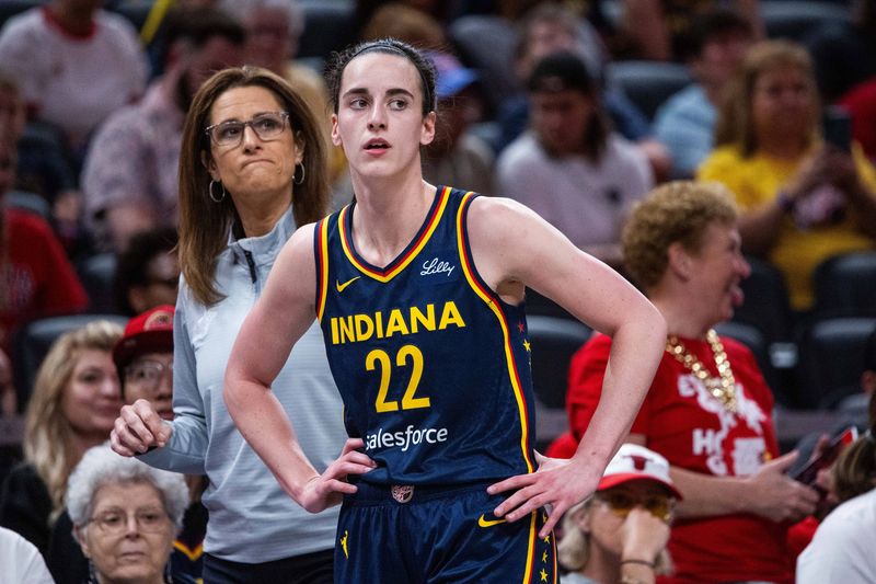 Jun 17, 2025; Indianapolis, Indiana, USA; Indiana Fever guard Caitlin Clark (22) and head coach Stephanie White in the first half against the Connecticut Sun at Gainbridge Fieldhouse. Mandatory Credit: Trevor Ruszkowski-Imagn Images