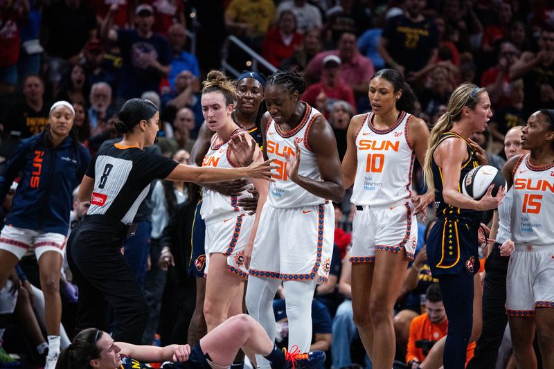 Jun 17, 2025; Indianapolis, Indiana, USA; Connecticut Sun guard Marina Mabrey (3) fouls Indiana Fever guard Caitlin Clark (22) in the second half at Gainbridge Fieldhouse. Mandatory Credit: Trevor Ruszkowski-Imagn Images
