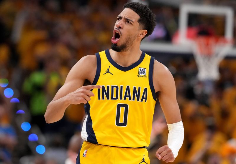 Indiana Pacers guard Tyrese Haliburton (0) celebrates a three point basket by teammate Aaron Nesmith (23) on Thursday, June 19, 2025, during Game 6 of the NBA Finals at Gainbridge Fieldhouse in Indianapolis.