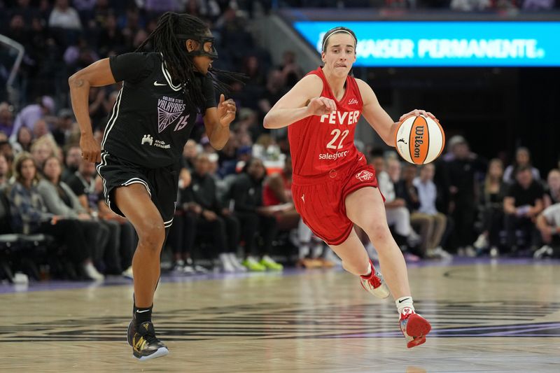 Jun 19, 2025; San Francisco, California, USA; Indiana Fever guard Caitlin Clark (22) dribbles against Golden State Valkyries guard Tiffany Hayes (15) during the third quarter at Chase Center. Mandatory Credit: Darren Yamashita-Imagn Images