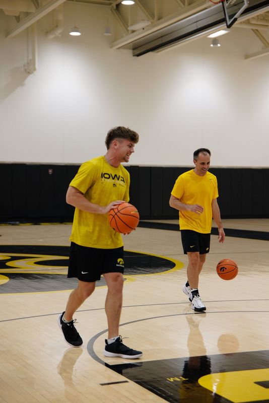 Super Bowl Champion Cooper DeJean and Iowa men's basketball coach Ben McCollum at a hoop session.