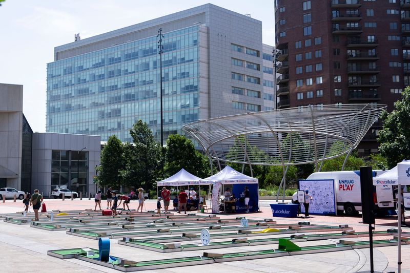 People play the Guinness World Records longest temporary mini golf hole during a USCellular Unplug and Play Day event at Cowles Commons on June 21, 2025, in Des Moines.