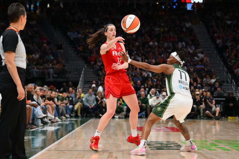 Jun 24, 2025; Seattle, Washington, USA; Indiana Fever guard Caitlin Clark (22) passes the ball over Seattle Storm guard Erica Wheeler (17) during the second half at Climate Pledge Arena. Mandatory Credit: Steven Bisig-Imagn Images