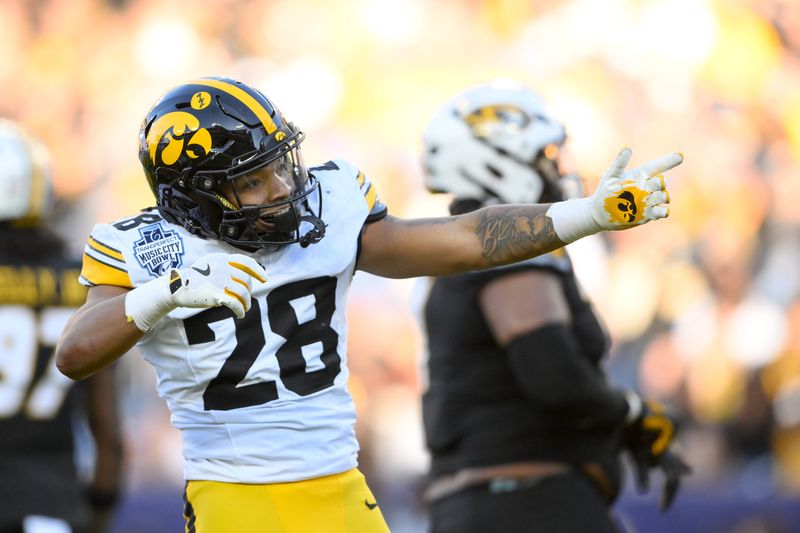 Dec 30, 2024; Nashville, TN, USA; Iowa Hawkeyes running back Kamari Moulton (28) celebrates his first down against the Missouri Tigers during the first half at Nissan Stadium. Mandatory Credit: Steve Roberts-Imagn Images