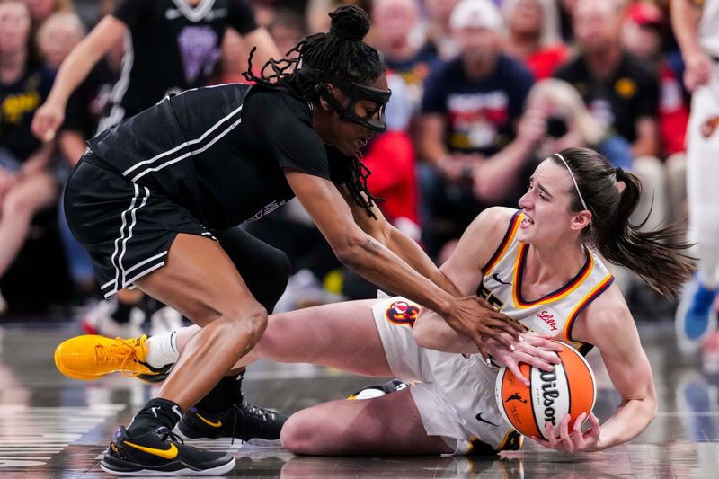 Golden State Valkyries guard Tiffany Hayes (15) and Indiana Fever guard Caitlin Clark (22) fight for the ball Wednesday, July 9, 2025, during a game between the Indiana Fever and the Golden State Valkyries at Gainbridge Fieldhouse in Indianapolis.