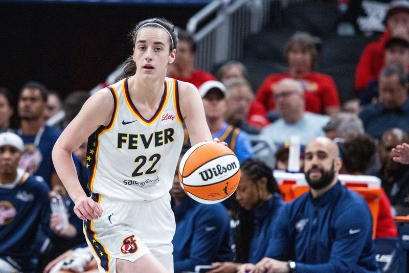 Jul 9, 2025; Indianapolis, Indiana, USA; Indiana Fever guard Caitlin Clark (22) dribbles the ball in the first half against Golden State Valkyries at Gainbridge Fieldhouse. Mandatory Credit: Trevor Ruszkowski-Imagn Images