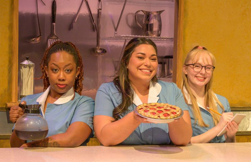 From left: Alicia Kodå Scott, Hannah Zepeda, and Emily Derick work at Joe’s Diner in "Waitress," through July 27, 2025, at The Des Moines Playhouse.