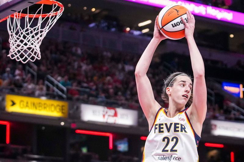 Indiana Fever guard Caitlin Clark (22) rebounds the ball Monday, Jan. 6, 2025, during a game between the Indiana Fever and the Golden State Valkyries at Gainbridge Fieldhouse in Indianapolis. The Golden State Valkyries defeated the Indiana Fever, 80-61.