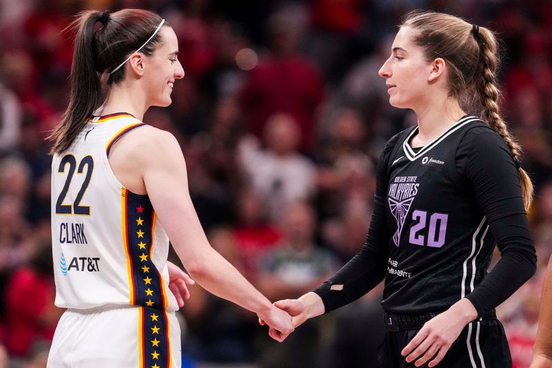Indiana Fever guard Caitlin Clark (22) greets Golden State Valkyries guard Kate Martin (20) on Wednesday, July 9, 2025, during a game between the Indiana Fever and the Golden State Valkyries at Gainbridge Fieldhouse in Indianapolis.