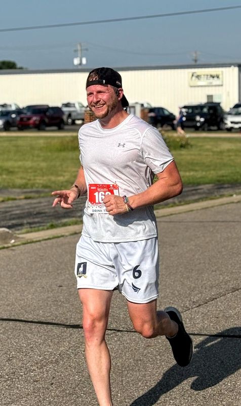 Dustin Klein runs down an airstrip in Battle Creek, Michigan, on July 5, 2025, while participating in the Battle Creek Half Marathon. The event, held in tandem with the Battle Creek Field of Flight Air Show & Balloon Festival is Battle Creek's only half marathon.