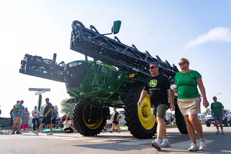 A John Deere tractor rolls through the Ankeny Summerfest Parade on July 12.