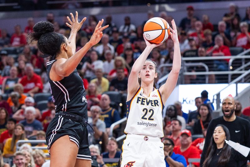 Jul 9, 2025; Indianapolis, Indiana, USA; Indiana Fever guard Caitlin Clark (22) shoots the ball while Golden State Valkyries forward Monique Billings (25) defends in the first half at Gainbridge Fieldhouse. Mandatory Credit: Trevor Ruszkowski-Imagn Images