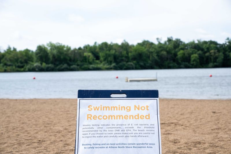 A sign warning visitors about the water's high E. Coli levels is seen on July 16, 2025, at Easter Lake Park in Des Moines.