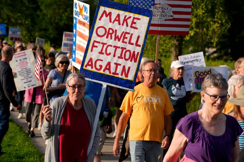 People march toward the Park Road bridge during a “Good Trouble Lives On” rally July 17, 2025 at Lower City Park in Iowa City, Iowa.