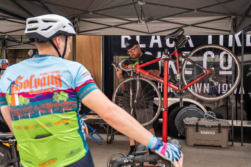 Matt Gerstandt of Black Tire Bike Company out of Marshalltown, Iowa, works on a bike during day zero of RAGBRAI 52 on July 19, 2025, at Windmill Park in Orange City, Iowa.